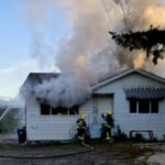Firefighters responding to residential house fire in North Surrey with heavy smoke