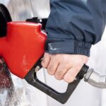 Gas station displaying fuel prices in Canada after tax reduction announcement