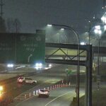 Emergency vehicles and police blocking lanes on Alex Fraser Bridge after fatal motorcycle crash at night