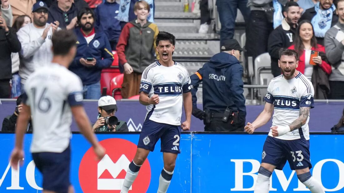 Vancouver Whitecaps players celebrating after scoring against New York City FC in MLS match at BC Place