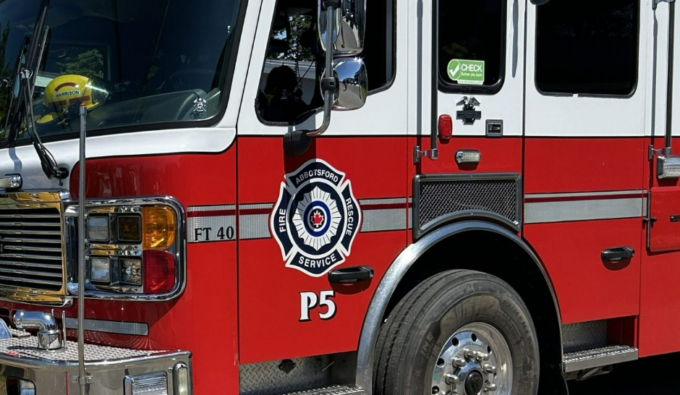 Emergency crews responding to a school fire in Abbotsford during early morning hours, with visible damage to the building.