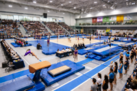 Gymnastics competition at Surrey sports complex with athletes and crowd