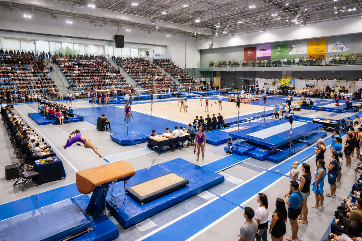 Gymnastics competition at Surrey sports complex with athletes and crowd