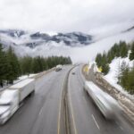 Snow-covered section of the Coquihalla Highway in British Columbia during winter driving conditions.