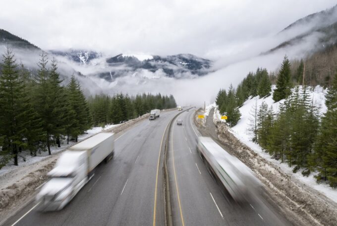 Snow-covered section of the Coquihalla Highway in British Columbia during winter driving conditions.