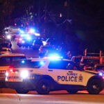 Police officers and emergency vehicles at the scene of a fatal shooting investigation in Surrey’s Newton neighbourhood.