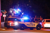 Police officers and emergency vehicles at the scene of a fatal shooting investigation in Surrey’s Newton neighbourhood.