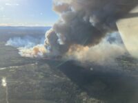 Smoke rising from active wildfires in British Columbia following lightning strikes during storm activity.