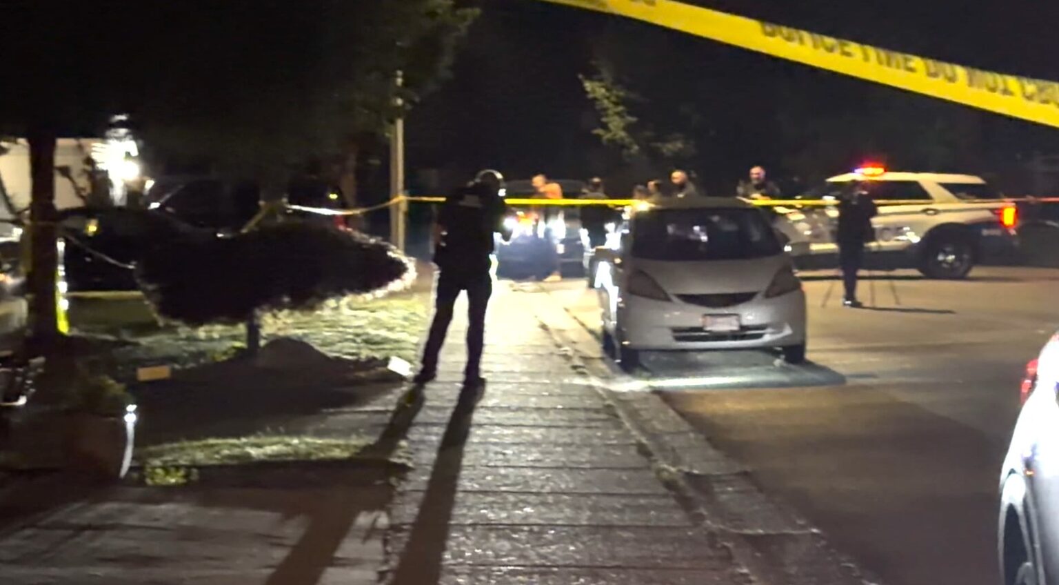 Police vehicles and emergency responders outside a Surrey neighbourhood during an active investigation.