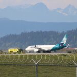 WestJet airplane on runway at Vancouver International Airport after returning due to technical issue