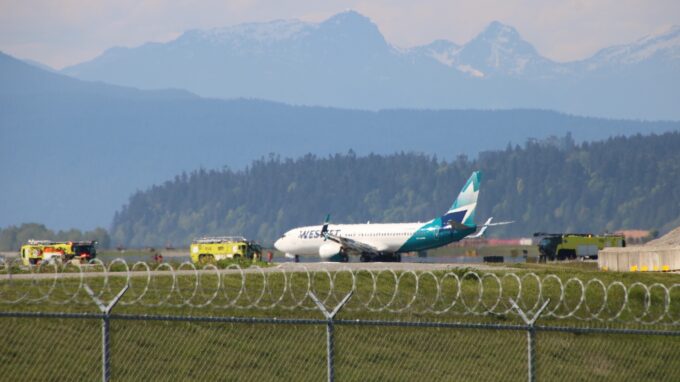 WestJet airplane on runway at Vancouver International Airport after returning due to technical issue