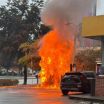 Technicians inspecting a damaged EV fast charging station after an electrical fire incident in British Columbia.