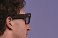 Person wearing modern smart glasses with AI-powered wearable technology features
