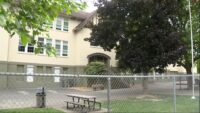 Police vehicles parked near a Vancouver elementary school during an investigation into an attempted child abduction.