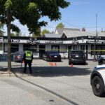 Police vehicles and crime scene tape at shooting investigation in Cloverdale Surrey