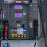 Close-up of a car being refueled at a gas station during rising fuel prices