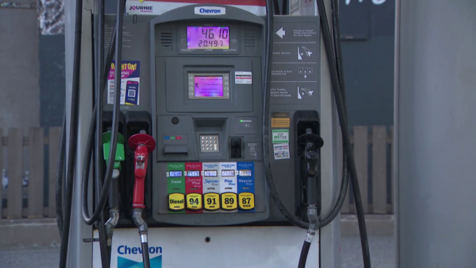 Close-up of a car being refueled at a gas station during rising fuel prices