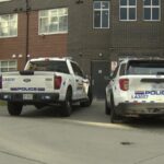 Police vehicles and officers responding to a targeted shooting scene in Langley, British Columbia.