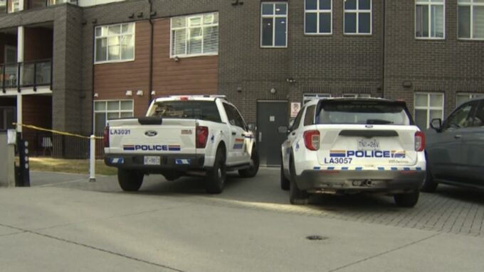 Police vehicles and officers responding to a targeted shooting scene in Langley, British Columbia.