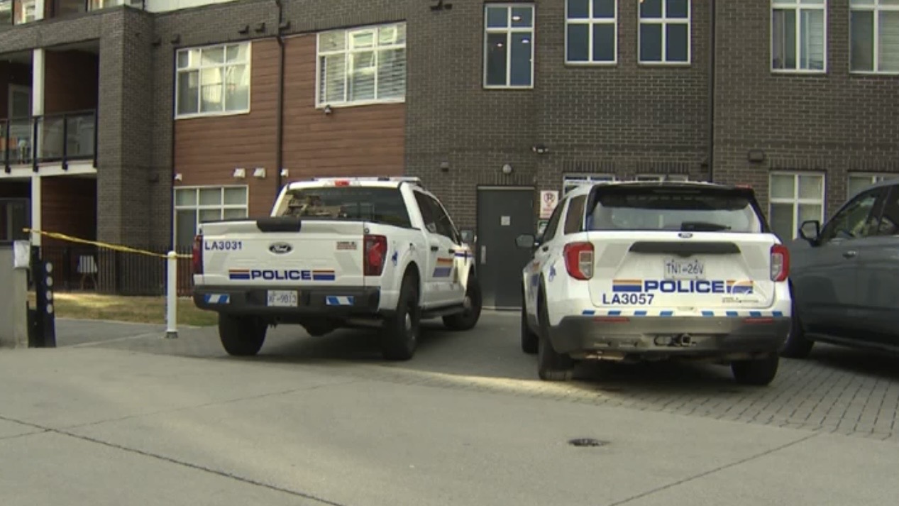 Police vehicles and officers responding to a targeted shooting scene in Langley, British Columbia.