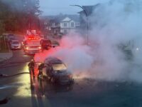 Firefighters battling a burning vehicle after an explosion in Surrey’s Newton neighbourhood.