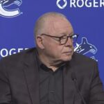 Vancouver Canucks branding and hockey atmosphere during a major organizational announcement.