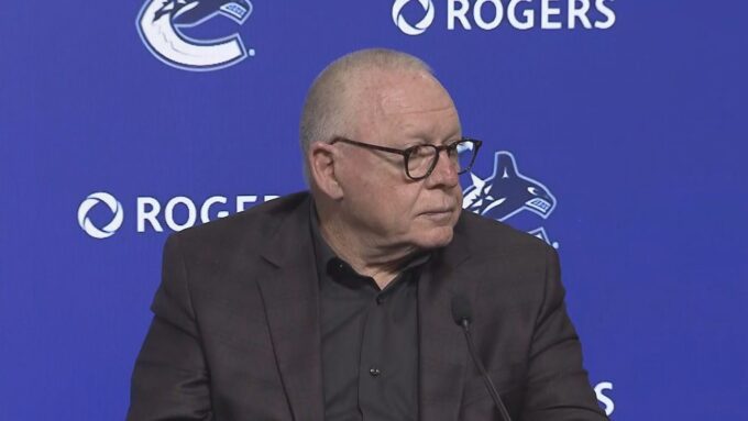 Vancouver Canucks branding and hockey atmosphere during a major organizational announcement.