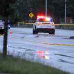 Police officers investigating a fatal pedestrian hit-and-run crash scene in Langley, British Columbia.