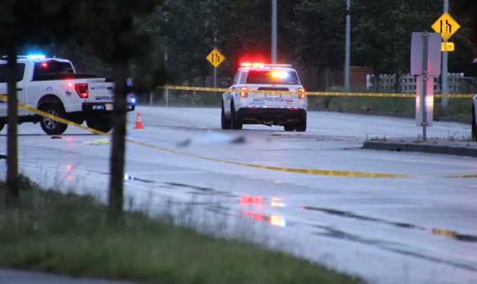 Police officers investigating a fatal pedestrian hit-and-run crash scene in Langley, British Columbia.