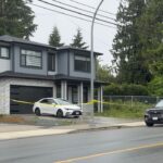 Police investigators outside a home in Mission, B.C. during a homicide investigation.