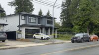 Police investigators outside a home in Mission, B.C. during a homicide investigation.