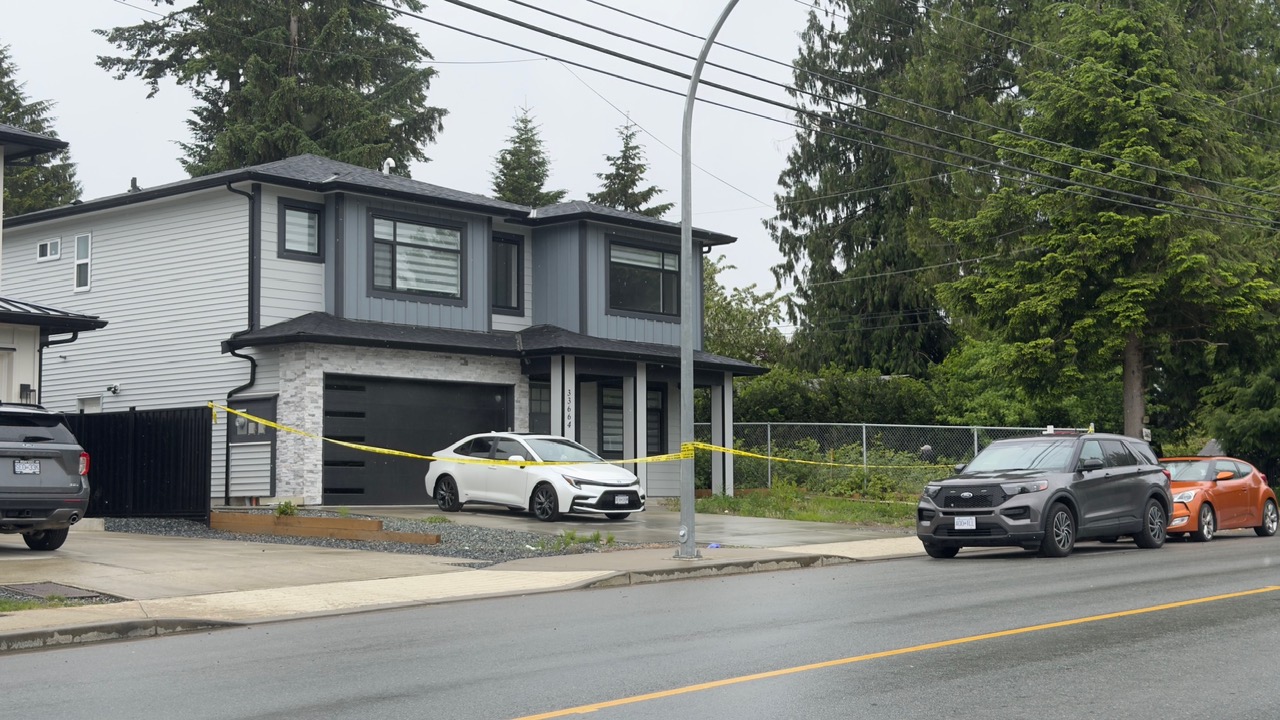 Police investigators outside a home in Mission, B.C. during a homicide investigation.