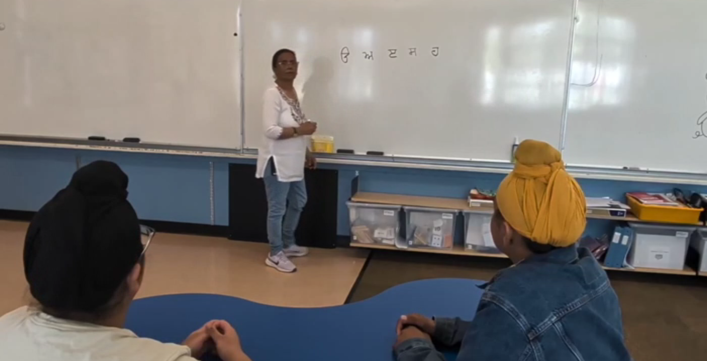 Students and parents discussing a Punjabi language initiative at a British Columbia elementary school amid online debate.