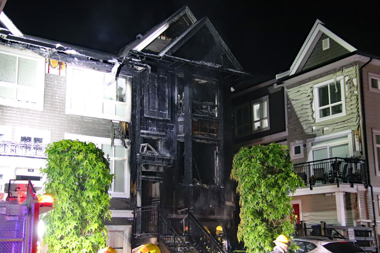 Firefighters responding to a major townhouse fire in Surrey that left one residential unit heavily damaged.
