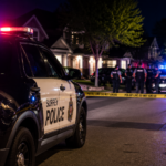 Police officers and emergency responders outside a Surrey residence following an officer-involved shooting.