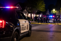 Police officers and emergency responders outside a Surrey residence following an officer-involved shooting.