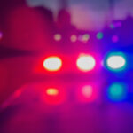 Police vehicles and emergency responders at a crime scene in Langley during a homicide investigation.