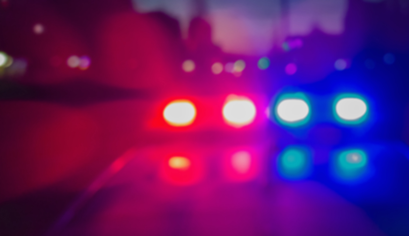 Police vehicles and emergency responders at a crime scene in Langley during a homicide investigation.
