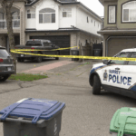 Surrey police investigating an extortion-linked shooting that resulted in additional criminal charges against two suspects.