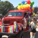 Crowd celebrating at Vancouver Pride Parade representing community support and diversity during annual Pride event in British Columbia.