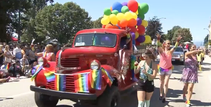 Crowd celebrating at Vancouver Pride Parade representing community support and diversity during annual Pride event in British Columbia.